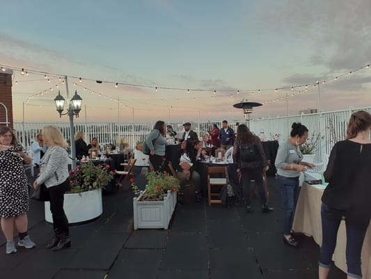 Residents and staff enjoying an outdoor gathering at sunset