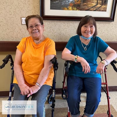 Two smiling residents in a hallway