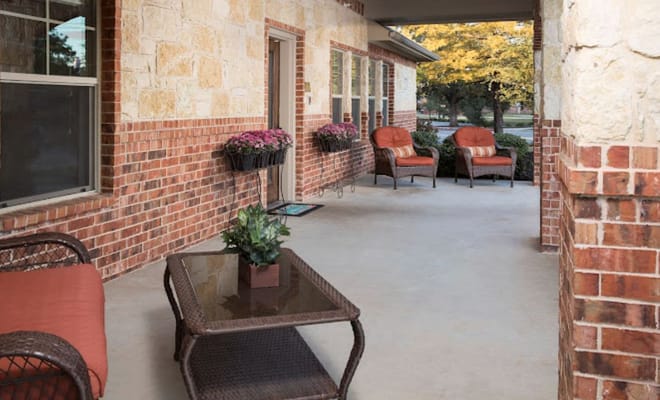 Cozy porch with seating and potted plants