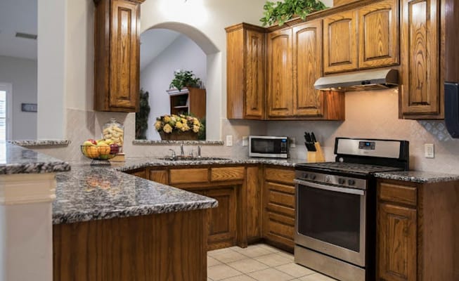Modern kitchen with wooden cabinets and granite countertops