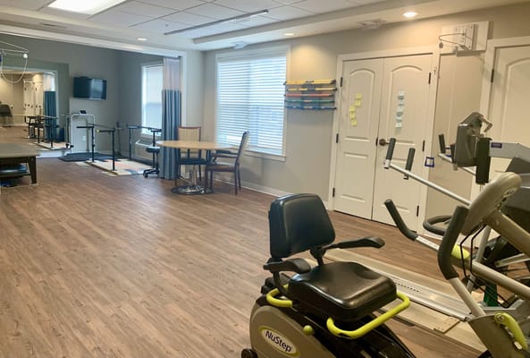 Interior view of a fitness area with equipment and a table