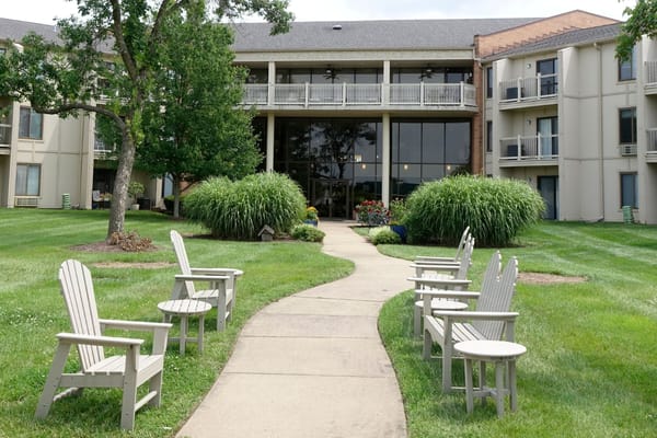 Outdoor seating area with a pathway and greenery
