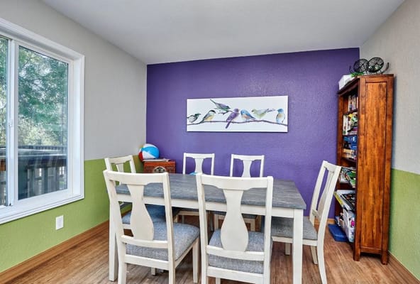 Dining area with colorful walls and a table