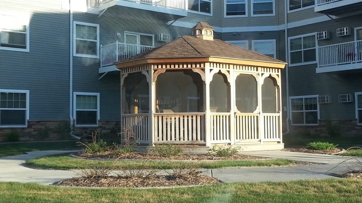 Outdoor gazebo surrounded by landscaped area