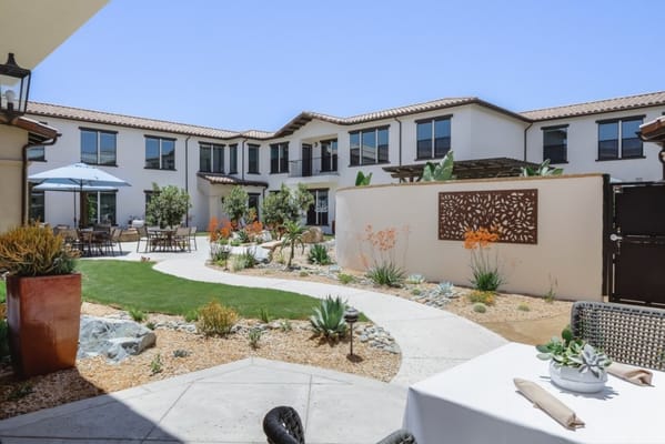 Bright outdoor courtyard with seating and landscaping