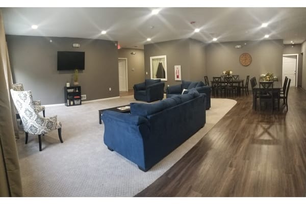 Bright and inviting common area with seating and dining space