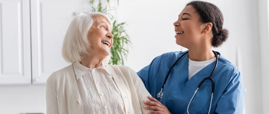 A caregiver sharing a joyful moment with a resident at PureHearts Assisted Living.