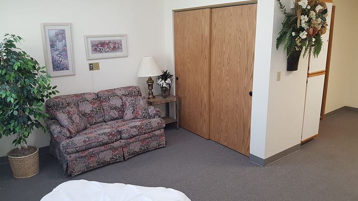 Cozy resident room with floral couch and decor