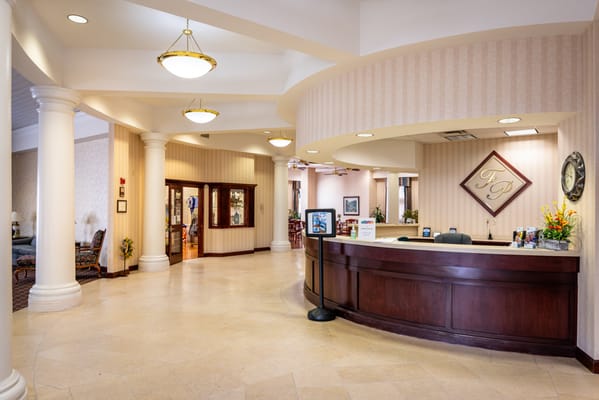 Bright reception area with a front desk and decor