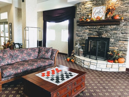 Cozy common area with a checkers table and autumn decor