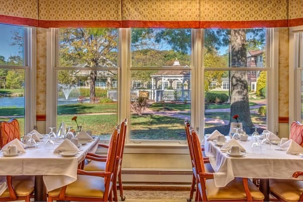 Dining area with tables set for meals and outdoor view