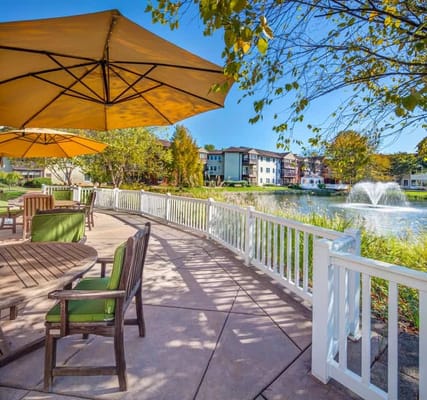 A serene outdoor area with seating and a pond