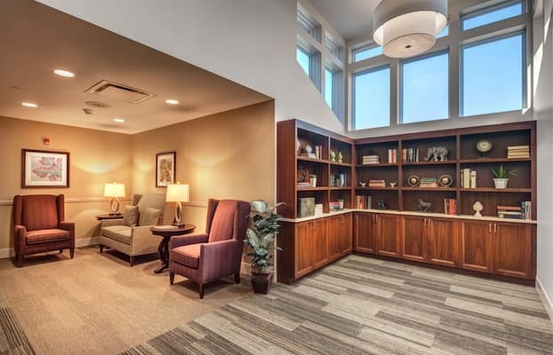 Cozy common area with seating and bookshelves