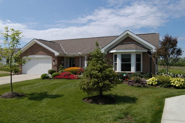 Exterior view of a senior living facility with landscaped garden