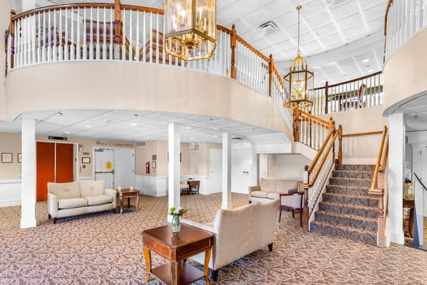 Bright lobby area with seating and staircase
