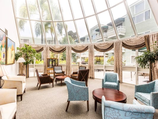 Bright common area with large windows and seating