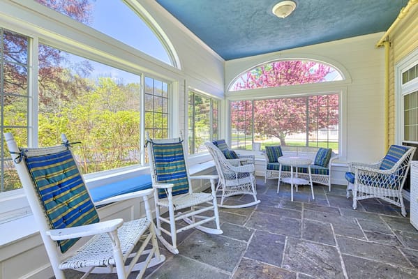 Sunroom with comfortable seating and garden view