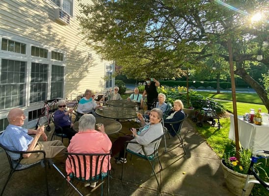 Seniors socializing outdoors at a nursing home