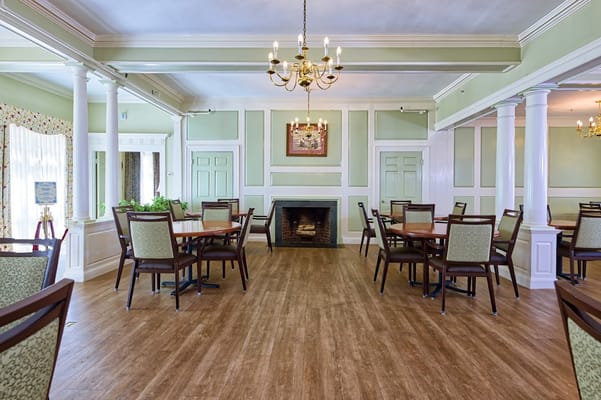 Dining area with tables and chairs in a light interior