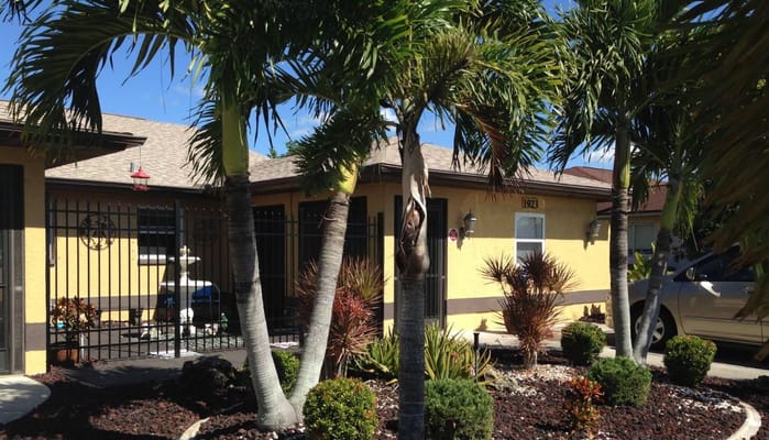 Exterior view of a residential care building with palm trees