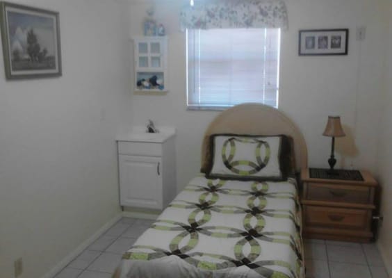 Cozy interior of a resident room with a bed and furnishings