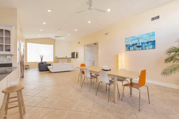 Bright and spacious common area with seating and dining table