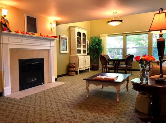 Cozy common area with a fireplace and seating.