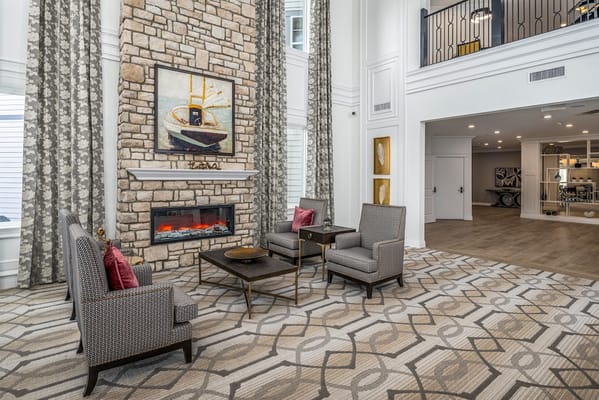 Bright interior common area with seating and fireplace