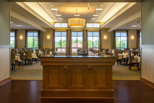 View of the dining room with tables set and large windows