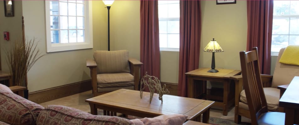 A cozy living room with comfortable seating and warm lighting.