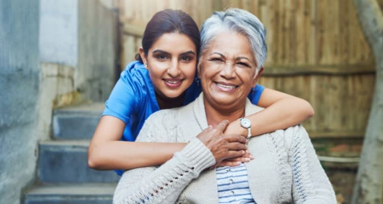 Two women smiling together outside