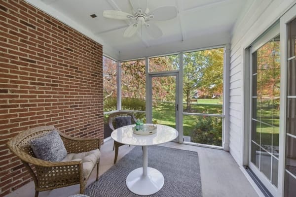 Cozy sunroom with seating and plants