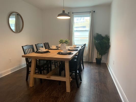 A bright dining room with a large wooden table