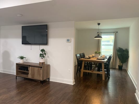 Dining area with a wooden table set for meals.