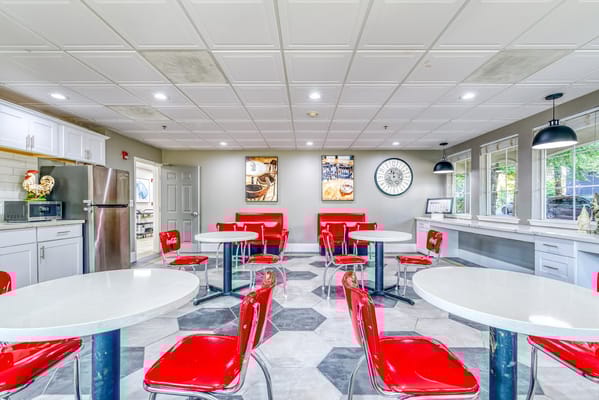 Bright and welcoming common area with red chairs