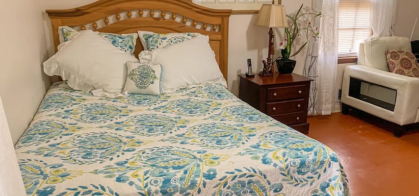 A neatly made bed with colorful bedding in a cozy bedroom