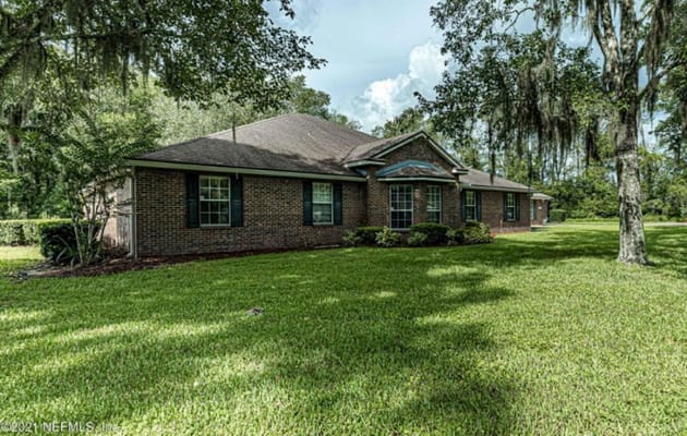 Exterior view of a senior living facility surrounded by greenery.