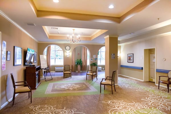 Spacious lobby with chairs and a decorative carpet