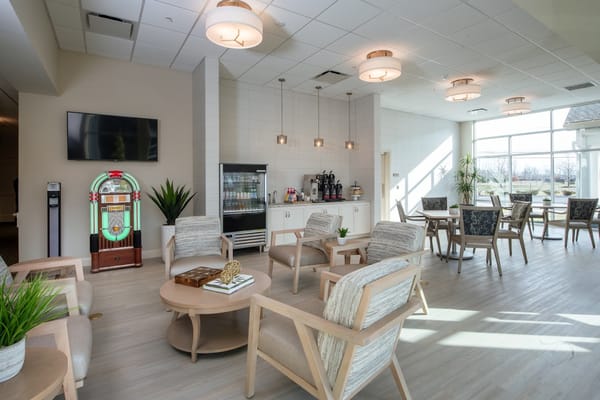 Bright common area with seating and a jukebox
