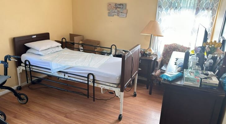 Interior view of a resident room with a bed and desk