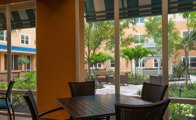 Indoor seating area with view of a landscaped courtyard