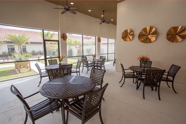Outdoor patio with tables and chairs at Symphony at St. Augustine.