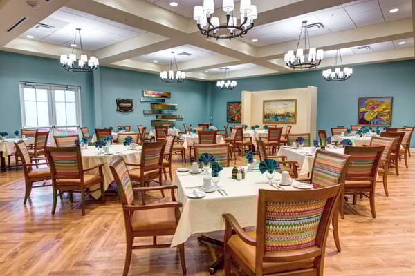 Elegant dining room with tables set for meals at Symphony at Stuart