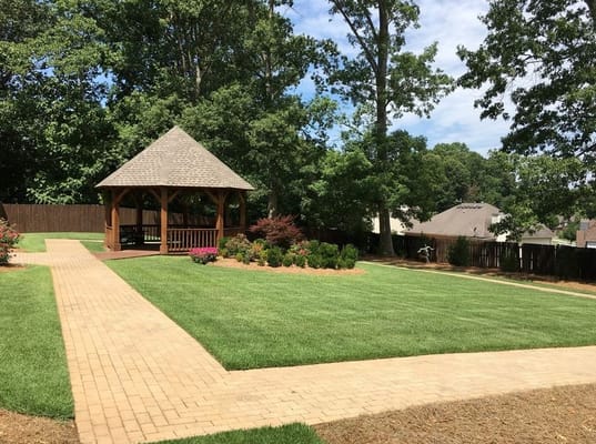 Well-maintained garden with a gazebo and pathways