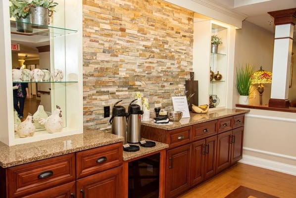 Cozy coffee station with decorative wall and snacks at Tennyson Court