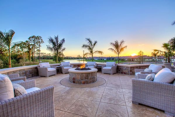 Outdoor seating area with a fire pit and sunset