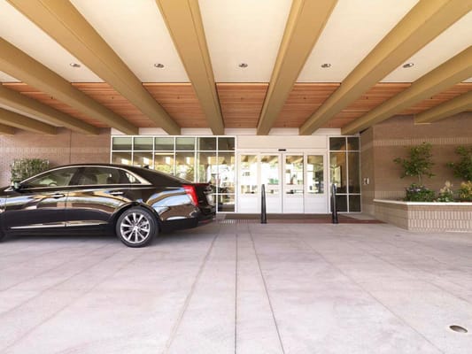The Avant senior living facility entrance with parked black car