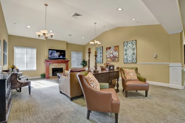 Comfortable lounge with sofas, piano, and decorative wall art