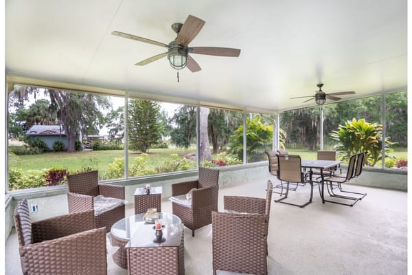 Indoor sunroom with seating and view of garden