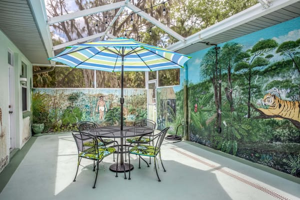 Outdoor patio with seating and mural
